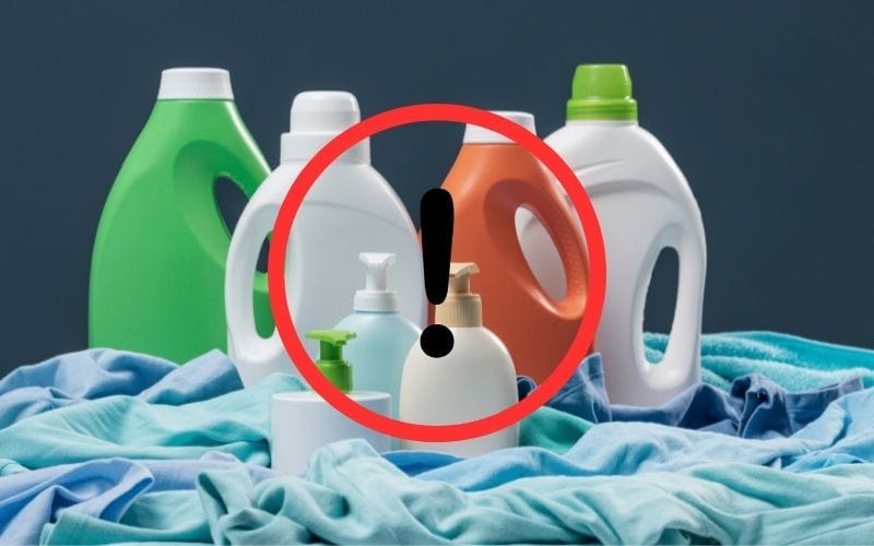 image with different bottles of liquid over some laundry with caution sign