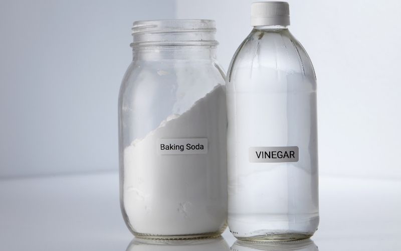 Image of a bottle of vinegar and a jar of baking soda