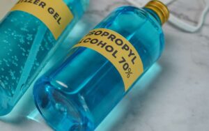 2 bottles with blue liquid and 1 bottle has a label Isopropyl alcohol