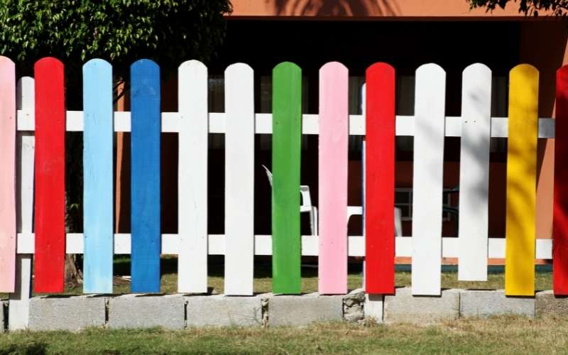 Photo of a colorful fence that can help to keep dogs from pooping in yard