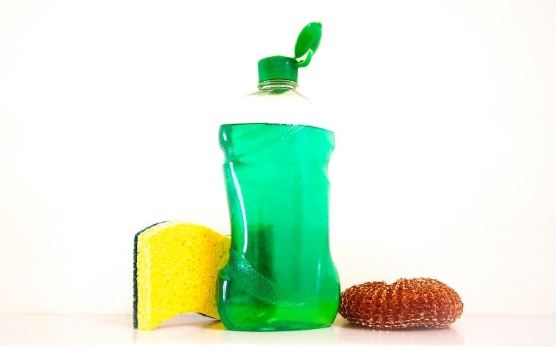 Photo of a bottled dish soap beside the sponges