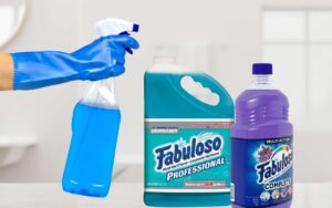 Image showing a hand with gloves holding a spray bottle beside a gallon and a container of fabuloso