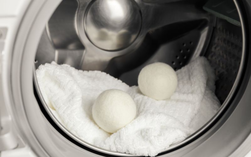 Photo of a dryer with two dryer balls over a white cloth